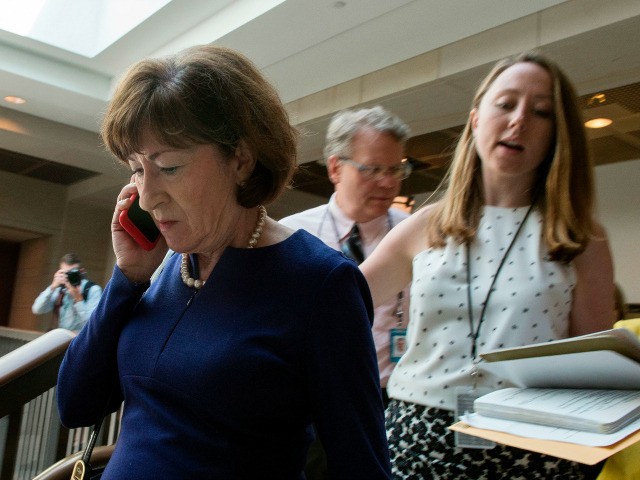 US Senator Susan Collins (L), Republican of Maine, walks to a room to read the report on t