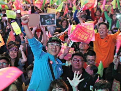 Supporters of Taiwan's 2020 presidential election candidate, Taiwan president Tsai Ing-wen cheer for Tsai's victory in Taipei, Taiwan, Saturday, Jan. 11, 2020. (AP Photo/Chiang Ying-ying)