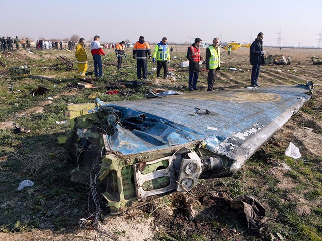 Rescue teams are seen on January 8, 2020 at the scene of a Ukrainian airliner that crashed shortly after take-off near Imam Khomeini airport in the Iranian capital Tehran. - Search-and-rescue teams were combing through the smoking wreckage of the Boeing 737 flight from Tehran to Kiev but officials said …