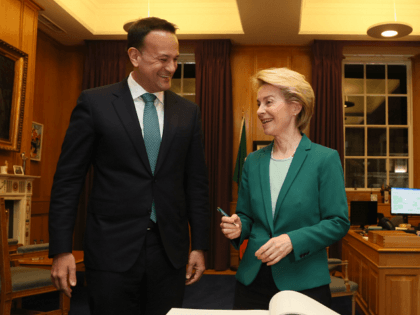 Ireland's Prime Minister Leo Varadkar stands with European Commission President Ursula von der Leyen as she signs the Visitors' Book during their meeting at Government Buildings in Dublin, on January 15, 2020. - The European Union's top official said Wednesday the bloc was ready to work "day and night" to …