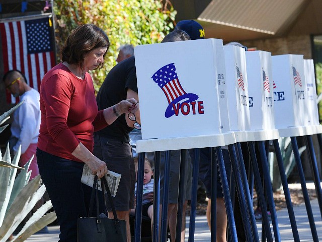 People vote at outdoor booths during early voting for the mid-term elections in Pasadena, California on November 3, 2018. (Photo by Mark RALSTON / AFP) (Photo credit should read MARK RALSTON/AFP via Getty Images)