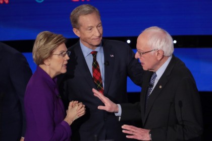 DES MOINES, IOWA - JANUARY 14: Sen. Elizabeth Warren (D-MA) and Sen. Bernie Sanders (I-VT) speak as Tom Steyer looks on after the Democratic presidential primary debate at Drake University on January 14, 2020 in Des Moines, Iowa. Six candidates out of the field qualified for the first Democratic presidential …