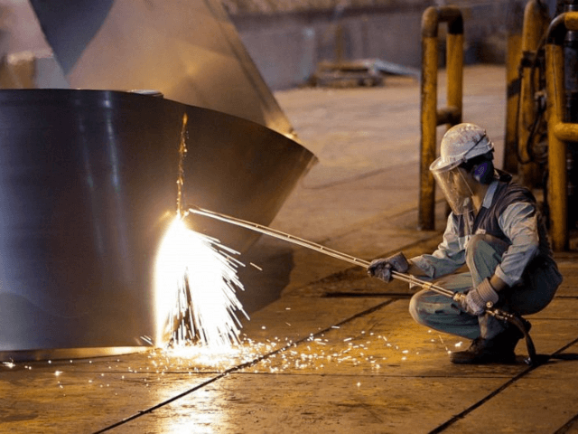 In this May 31, 2012 file photo, an Iranian worker cuts a steel roll at the Mobarakeh Stee