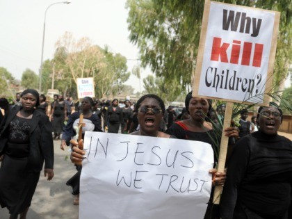 Thousands of women in black, one of them carrying a placard reading "Why Kill Children ?" as they march in protest at the slaughter of scores of mainly Christian villagers -- many of them women and children. Wielding pictures of dead children and carrying Bibles in their hands, wailing Nigerian …