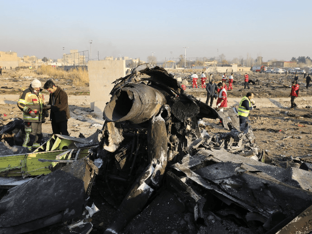 In this Wednesday, Jan. 8, 2020 file photo debris at the scene where a Ukrainian plane crashed in Shahedshahr southwest of the capital Tehran, Iran. Two U.S. officials said Thursday that it was “highly likely” that an Iranian anti-aircraft missile downed a Ukrainian jetliner late Tuesday, killing all 176 people …