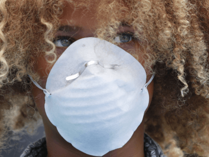 Levi Draheim, 11, wears a dust mask as he participates in a demonstration in Miami in July 2019. A lawsuit filed by him and other young people urging action against climate change was thrown out by a federal appeals court Friday. Wilfredo Lee/AP