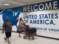 International travelers leave the Customs and Immigration area of Dulles International Airport (IAD) June 29, 2017, outside Washington, DC, in Dulles, Virginia. The US began implementing a ban on travelers from six mostly Muslim countries, amid fresh controversy about who is exempt: those with "close family relationships" can get visas, …