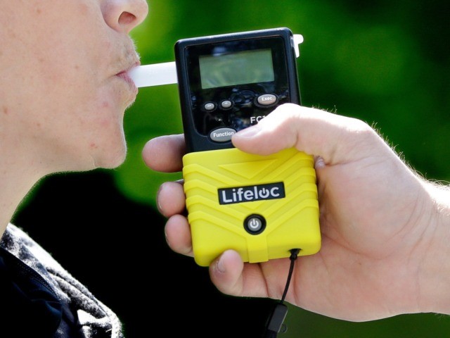 California Highway Patrol Sgt. Jaimi Kenyon blows into a breathalyzer held by Sacramento Police Corporal Luke Moseley during a demonstration of devices used to test drivers suspected of impaired driving Wednesday, May 10, 2017, in Sacramento, Calif. Breathalyzers are commonly used to detect alcohol but a new device tested by …