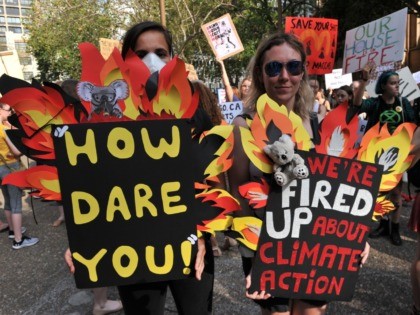 Participants hold placards as they take part in a demonstration demanding the government take immediate action against climate change in Sydney on January 10, 2020, in the wake of deadly bushfires that have killed at least 26 people and destroyed more than 2,000 homes in southeastern Australia. - Tens of …