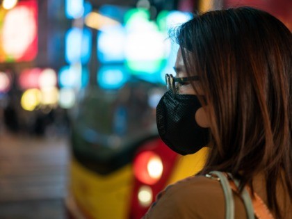 HONG KONG, CHINA - JANUARY 23: Pedestrians wear face masks as they walk through a crosswalk in Causeway Bay district on January 23, 2020 in Hong Kong, China. Hong Kong reported its first two cases of Wuhan coronavirus infections as the number of those who have died from the virus …
