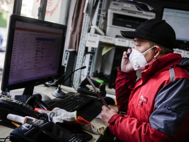 WUHAN, CHINA - JANUARY 29: (CHINA OUT) A courier checks orders on a computer in an Express station on January 29, 2020 in Hubei Province, Wuhan, China. Due to a transit shut down and lack of supplies, couriers have became the city's suppliers. The 2019 coronavirus (2019-nCoV), which originated in …