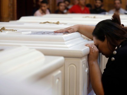 A relative of a slain Christian grieves during funeral service at Church of Great Martyr Prince Tadros, in Minya, Egypt, Saturday, Nov. 3, 2018. Coptic Christians in the Egyptian town of Minya prepared to bury their dead, a day after militants ambushed three buses carrying Christian pilgrims on their way …