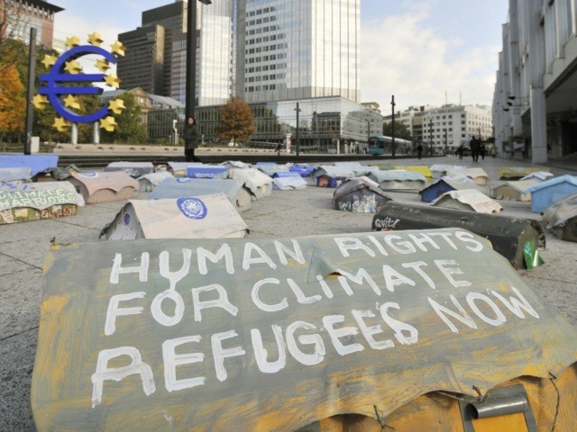 A miniature tent inscribed with the words "Human Rights for Refugees Now" outside the head