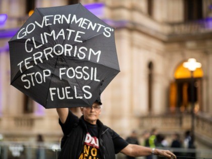 BRISBANE, AUSTRALIA - JULY 05: An Adani protester is seen holding a placard in Brisbane Sq