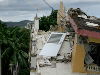 A collapsed structure lies after the previous day's magnitude 6.4 earthquake in Yauco, Puerto Rico, Wednesday, Jan. 8, 2020. The quake that struck before dawn on Tuesday killed one person, injured nine others and knocked out power across the U.S. territory. (AP Photo/Carlos Giusti)