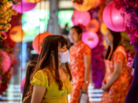 A woman with a face mask walks in a shop decorated for the Chinese Lunar New Year in Bangkok on January 24, 2020, after four people were detected with the Coronavirus in Thailand. (Photo by Mladen ANTONOV / AFP) (Photo by MLADEN ANTONOV/AFP via Getty Images)