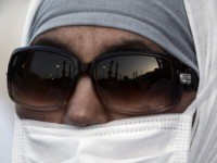 A Muslim pilgrim wearing a mask arrives for a prayer at Mecca's Grand Mosque, home of the cube-shaped Kaaba or "House of God" that Muslims believe was built by Abraham 4,000 years ago, on September 29, 2014 as hundreds of thousands of Muslim worshipers started pouring into the holy city …