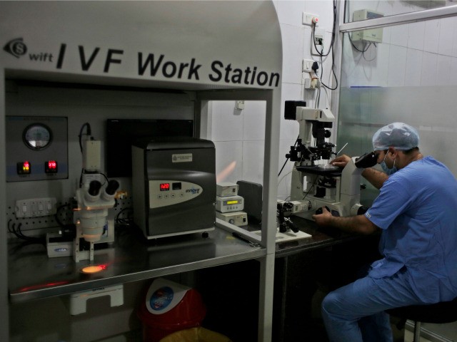 In this Dec. 22, 2016 photo, a pathologist works in a laboratory inside the National Fertility and Test Tube Baby Centre in Hisar, India. Most medical ethics guidelines around the world recommend a cut-off between 45 and 50 for treatments like IVF, and the Indian Medical Council sets 45 as …