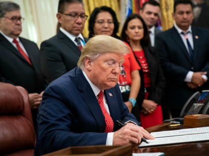 WASHINGTON, DC - NOVEMBER 26: U.S. President Donald Trump signs an executive order establishing the Task Force on Missing and Murdered American Indians and Alaska Natives, in the Oval Office of the White House on November 26, 2019 in Washington, DC. Attorney General William Barr recently announced the initiative on …