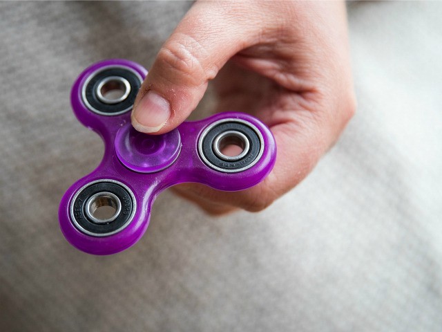 In this photo illustration, a woman holds a fidget spinner, May 5, 2017 in the Brooklyn bo