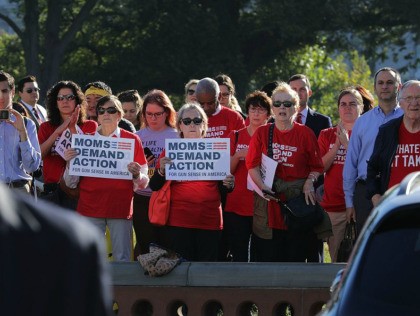 WASHINGTON, DC - OCTOBER 04: Anti-gun violence activists from Moms Demand Action stand at a distance as House Democrats rally on the East Front steps of the U.S. House of Representatives October 4, 2017 in Washington, DC. The Democratic members of Congress held the rally to honor the victims of …