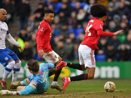 Manchester United's Dutch midfielder Tahith Chong (R) is fouled by Tranmere Rovers' English goalkeeper Scott Davies, giving away a penalty during the English FA Cup fourth round football match between Tranmere Rovers and Manchester United at Prenton Park in Birkenhead, north west England, on January 26, 2020. (Photo by Paul …
