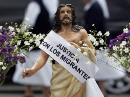 Guatemala City, GUATEMALA: A figure of Jesus which asks for "justice with the migrants and no more deportations" is pictured in the Constitution Place where members of the Episcopal Conference take part in the Via Crucis of the Migrant in the Historic Centre of Guatemala City, 23 March 2007. The …