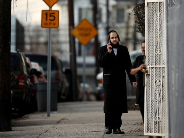 JERSEY CITY, NJ - DECEMBER 11: A member of the Jewish community talks on his phone near th