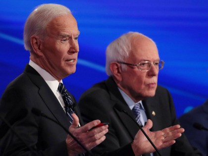 DES MOINES, IOWA - JANUARY 14: Sen. Bernie Sanders (I-VT) and former South Bend, Indiana Mayor Pete Buttigieg (R) listen as former Vice President Joe Biden (L) speaks during the Democratic presidential primary debate at Drake University on January 14, 2020 in Des Moines, Iowa. Six candidates out of the …