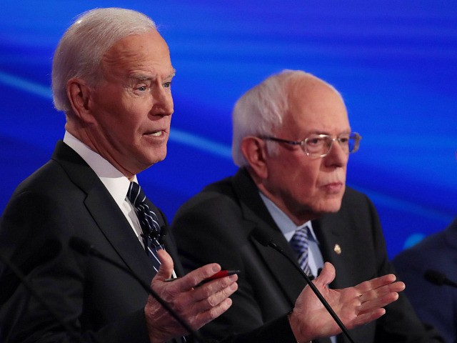 DES MOINES, IOWA - JANUARY 14: Sen. Bernie Sanders (I-VT) and former South Bend, Indiana Mayor Pete Buttigieg (R) listen as former Vice President Joe Biden (L) speaks during the Democratic presidential primary debate at Drake University on January 14, 2020 in Des Moines, Iowa. Six candidates out of the …