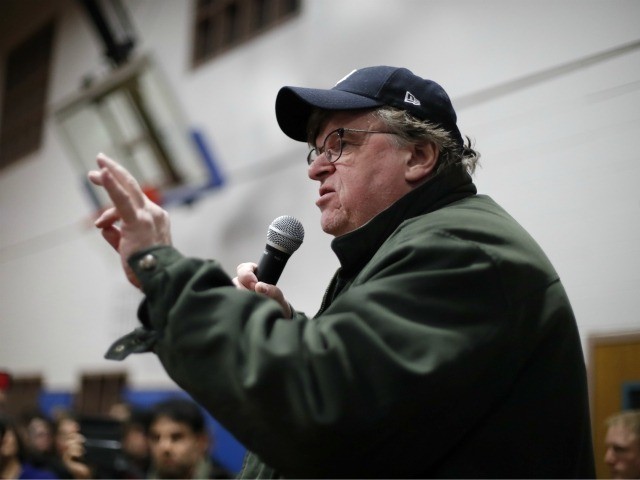 Filmmaker Michael Moore speaks to the overflow crowd before a rally for Democratic presidential candidate Sen. Bernie Sanders, I-Vt., at the Ames City Auditorium in Ames, Iowa, Jan. 25, 2020. (AP Photo/Gene J. Puskar)