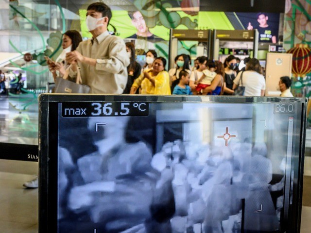 OPSHOT - People with protective face masks pass in front of a thermal scanner as they ente