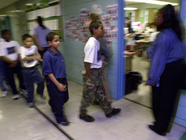 379693 13: Students at "Knowledge is Power Program" (KIPP) Academy walk in strict formatio