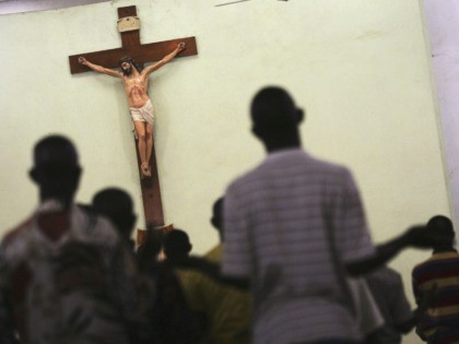 KANO, KANO - APRIL 12: Nigerian Catholic worshippers stand and pray during morning mass April 12, 2005 in Kano, Nigeria. Kano is part of Nigeria's primarily Muslim north, but devoted Catholic minority participates in frequent Masses in local cathedrals. Cardinal Francis Arinze of Nigeria is considered a leading contender to …
