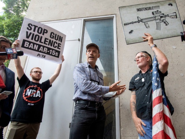 National Rifle Association member and Donald Trump supporter Jim Whelan, center, converses