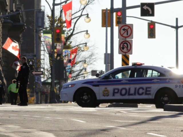 OTTAWA, CANADA - OCTOBER 22: Police officers secure the area near Parliament Hill on October 22, 2014 in Ottawa, Canada. At least one gunman shot and killed a Canadian soldier standing guard at the National War Memorial before entering the House of Commons inside the main Parliament building and opening …