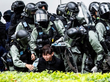 OPSHOT - A man (C) has pepper spray washed from his his face by police after being detained during a clearance operation after a demonstration against parallel trading in Sheung Shui in Hong Kong on January 5, 2020. - In recent years Sheung Shui has been swamped by a huge …