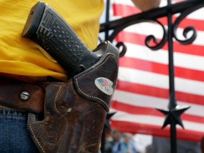 A man wears an unloaded pistol during a pro gun-rights rally at the state capitol, Saturday, April 14, 2018, in Austin, Texas. Gun rights supporters rallied across the United States to counter a recent wave of student-led protests against gun violence. (AP Photo/Eric Gay)