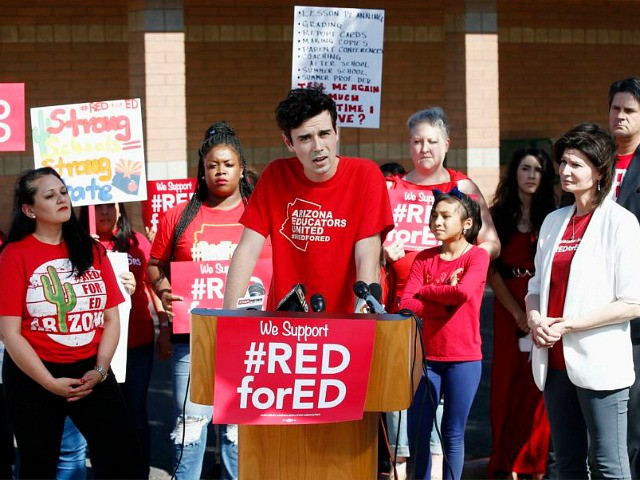 Music teacher Noah Karvelis, center, who helped organize Arizona Educators United, speaks at a news conference at the Esperanza Elementary School in Isaac School District speaking on teacher pay and school funding Wednesday, April 25, 2018, in Phoenix. Arizona teachers are scheduled to go on strike Thursday. (AP Photo/Ross D. …