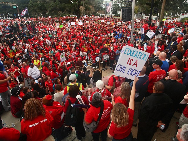 Teachers and supporters march Monday, Jan. 13, 2020, during the Florida Education Association's "Take on Tallahassee" rally at the Old Capitol in Tallahassee, Fla. (AP Photo/Phil Sears)