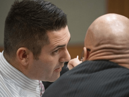 In this photo taken Tuesday, Dec. 3, 2019, dentist Seth Lookhart talks with his lawyer Paul Stockler during his trial in Anchorage, Alaska. The Alaska dentist is accused of fraud and unnecessarily sedating patients and also performing a procedure while riding a wheeled, motorized vehicle known as a hoverboard, authorities …