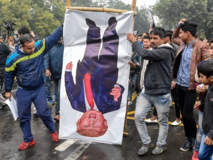 People hold a poster representing US President Donald Trump (C) to protest against the US authorities for the killing of Iranian commander Qasem Soleimani in Iraq, during a demonstration near the US embassy in New Delhi on January 7, 2020. - A US drone strike killed top Iranian commander Qasem …