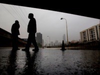 Israeli Police officers block the flooded Ayalon freeway in Tel Aviv, Israel,Tuesday, Jan. 8, 2013. Heavy rains flooded Tel Aviv. (AP Photo/Ariel Schalit)