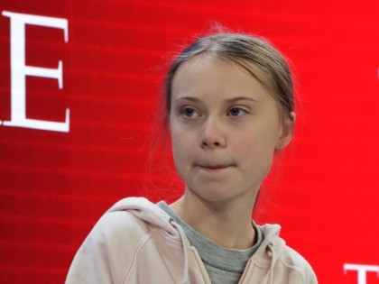 Swedish environmental activist Greta Thunberg takes her seat prior to the opening session