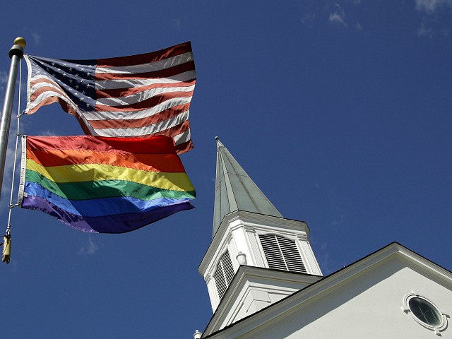 FILE - In this April 19, 2019, file photo, a gay pride rainbow flag flies along with the U