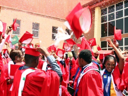 Class of 2015 graduating students of the American University of Nigeria in Yola, Adamawa state, celebrate after their commencement ceremony at the school on May 9, 2015. Amongst them is Abubakar Umar, a 26-year-old petroleum chemistry student who survived a Boko Haram attack last November as he travelled home to …