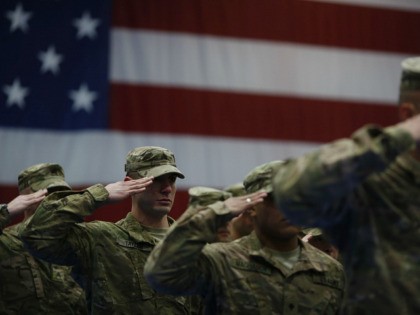 Soldiers from the U.S. Army's 3rd Brigade Combat Team, 1st Infantry Division, salute during the playing of the Star Spangled Banner during a homecoming ceremony in the Natcher Physical Fitness Center on Fort Knox on February 27, 2014 in Fort Knox, Kentucky. About 100 soldiers returned to Fort Knox after …