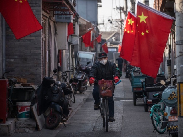 viral BEIJING, CHINA - JANUARY 31: A Chinese man wears a protective mask as he rides his b