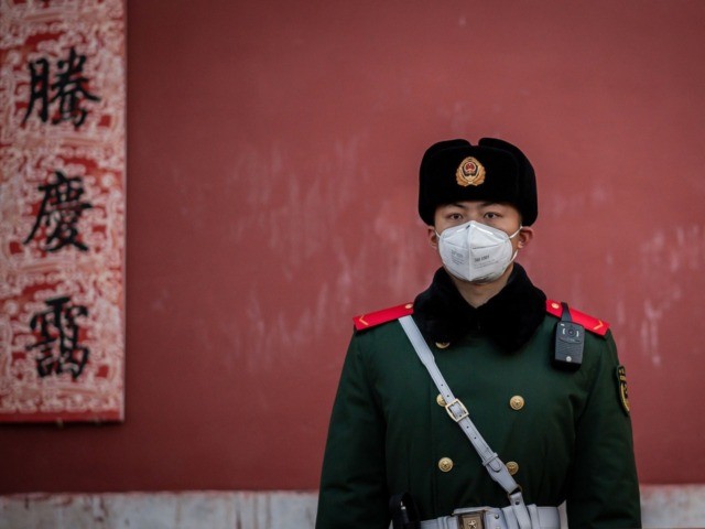 A paramilitary police officer wearing a protective facemask to help stop the spread of a d