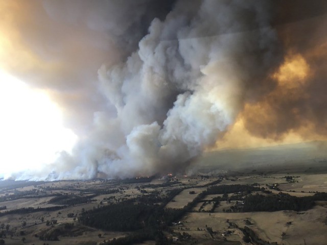 APTOPIX Australia Wildfires In this Monday, Dec. 30, 2019, aerial photo, wildfires rage under plumes of smoke in Bairnsdale, Australia. Thousands of tourists fled Australia's wildfire ravaged eastern coast Thursday ahead of worsening conditions as the military started to evacuate people trapped on the shore further south. (Glen Morey via AP) The Associated Press
